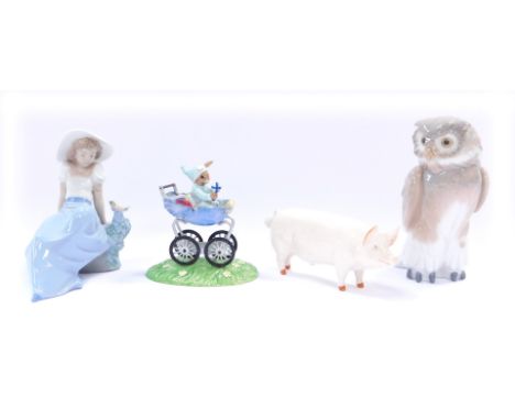 A group of ornaments, comprising a Beswick wall boy pig, Nao owl, Nao figure of a lady with bird on rock, and a Bunnykins Chr