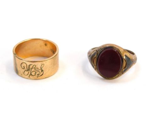 Two rings, comprising a 9ct gold signet ring, with red blood stone, and later soldered detail, ring size O, together with a w