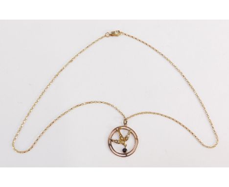 An Edwardian pendant and chain, the circular swallow pendant set with seed pearls with a garnet set drop, 3cm diameter, yello