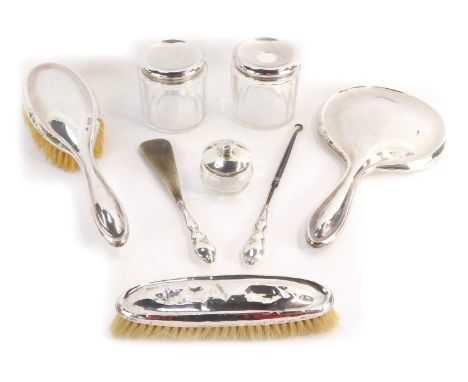 A George V silver dressing table set, comprising hand brush, two dressing table cut glass jars and lids, a miniature cut glas