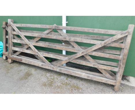 A pair of wooden swing garden five bar gates, each gate 305cm wide, 132cm high.