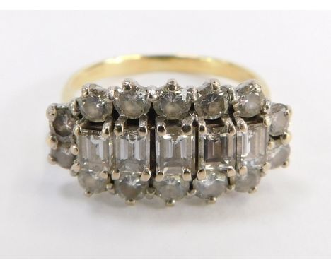 A diamond cluster ring, the panel set with five square cut diamonds, surrounded by round brilliant cut diamonds, totalling ap