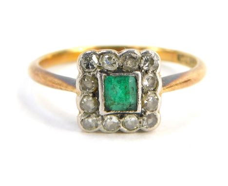 An emerald and diamond cluster ring, the square set panel with square cut emerald in rub over setting, surrounded by diamonds