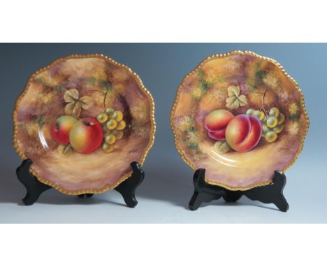 Royal Worcester, a pair of fruit decorated plates, one decorated with peaches and grapes, the other with apples and grapes, s