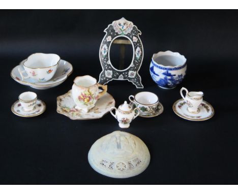 A small collection of cabinet miniatures, including a sugar basin, milk jug, cup, sauce and plate, a German cup and saucer, a