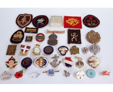 A collection of gilt metal and enamel badges, to include an RAF cap badge, a silver A.P.R badge and a War Service  badge 1904