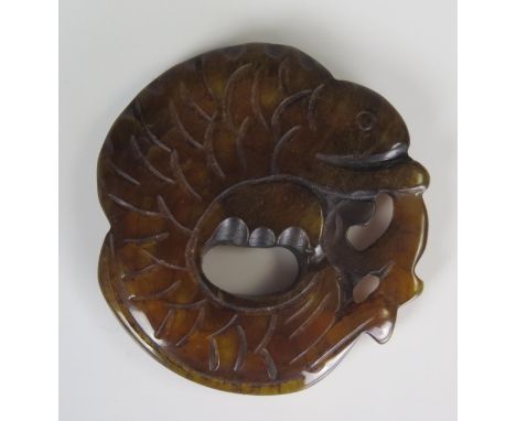 A Chinese hardstone Bi disc in the form of s lizard, possibly brown jade, 5.5cm diameter.