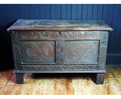 A late 17th Century oak coffer, the two plank lid with cleated end, one wire hinge or replaced, two panel front and rails wit