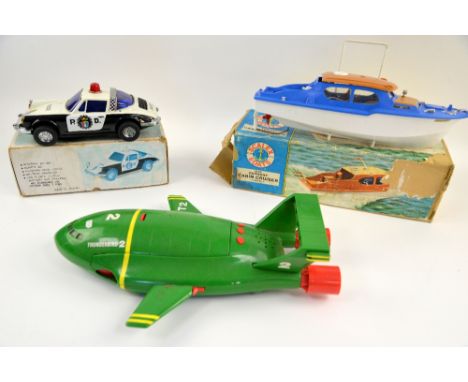 A Scalex Boats Derwent Cabin Cruiser 414S, a Taiwan-made battery operated Mystery Action Police Car, both boxed, and a large 