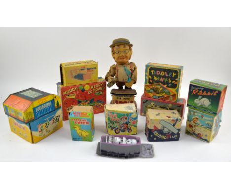 A group of predominantly tin plate and clockwork toys including a Japanese battery operated 'Charley Weaver Bartender', wind-