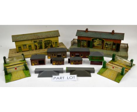 A group of Hornby tinplate crossings and platforms and a quantity of plastic buildings and platforms. (qty)Provenance: Single