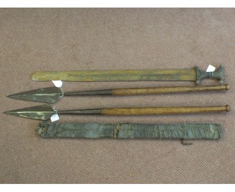 Two wooden shafted spears with an African sword with leather bound grip and scabbard