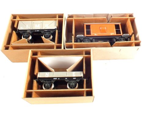 A boxed Bassett Lowke 1x3 plank wagon N.E. 1x7 plank coal wagon LMS x 20 ton brake van BR (with working light)
