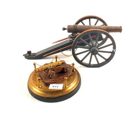 A model of a 19th Century Artillery field gun with a model of a Naval gun on Brass stand