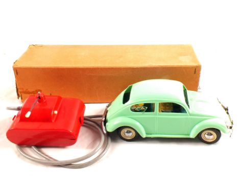 A boxed Mignon remote controlled battery powered Volkswagen Beetle in light green