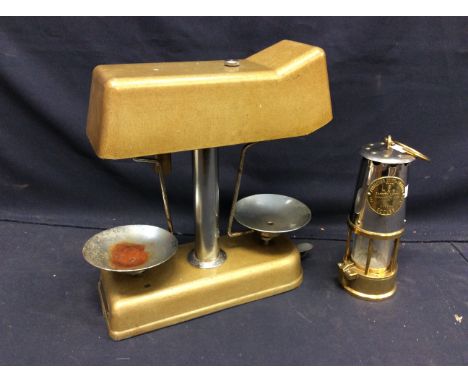  A 1960s universal money checker weighing scales along with a Eccles miners lamp.