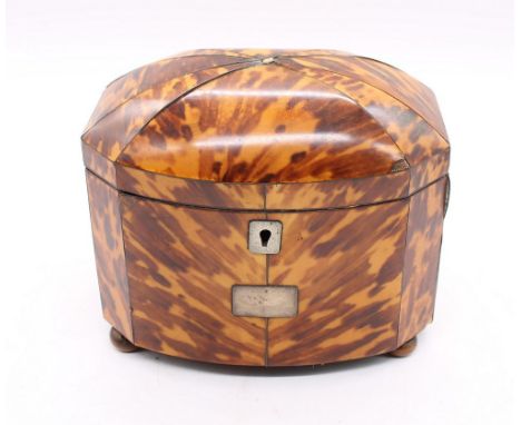 A mid 19th Century tortoiseshell two compartment tea caddy on bun feet.