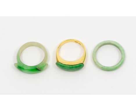 A jadeite and 18ct gold ring, size L, total gross weight approx 5gms, stamped 750, along with two other jadeite type bands (1