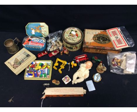 A collectors lot to include; a small 20th century unmarked Doll, a Pluto soft toy, toys from Christmas crackers, miniature Co