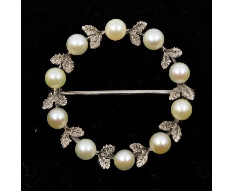 A pearl and white metal garland brooch, set with small cultured pearls and leaf decoration, diameter approx 25mm, pin and rol