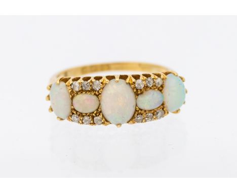 ***AUCTIONEER TO ANNOUNCE CHIP TO ONE SMALLER OPAL**** An opal 18ct gold ring, comprising graduated oval opals with small dia