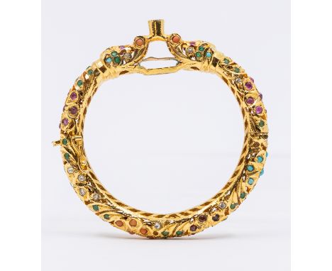 Mughal style gilt metal stone set bangle, comprising dragon heads set with various tones including coral, ruby, garnet, turqu