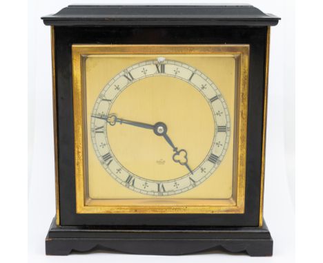 An ebonised Elliot mantel clock with Roman numerals and brass dial.