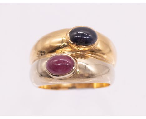 A sapphire and ruby two tone 18ct gold dress ring, comprising an 18ct white gold band set with an oval cabochon ruby approx 6