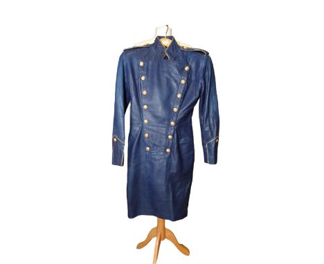A royal blue supple leather dress in military style, studded brass buttons in a double breasted design, collar edged in gold 