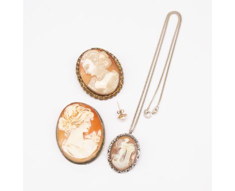 Three vintage shell cameo pendant brooches, comprising two in white metal (one with a silver chain) together with a gilt meta