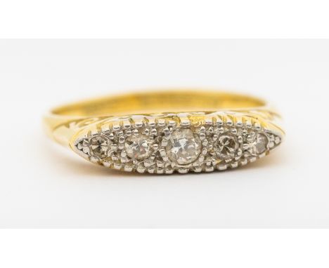 A diamond and 18ct five stone boat head ring, comprising five graduated diamond set in platinum to a yellow gold scrolled mou