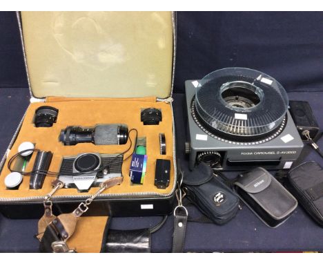 A collection of camera equipment to include Praktica camera in case with accessories and lenses, other cameras and a slide pr