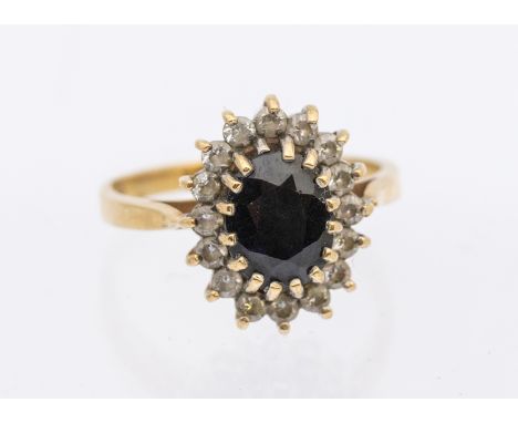 A sapphire and quartz set cluster ring, comprising a central mixed cut sapphire approx 7 x 5mm within a border of white stone
