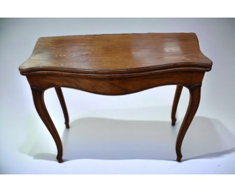 A George III mahogany serpentine games/card table with 20th Century fabric playing top, cabriole legs along with a George III