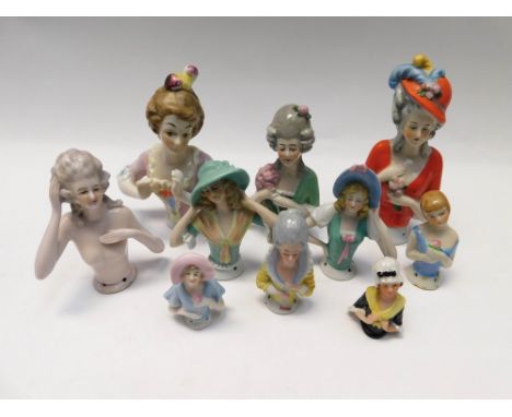 A collection of ceramic early 20th century in cushion dolls in a variety of styles