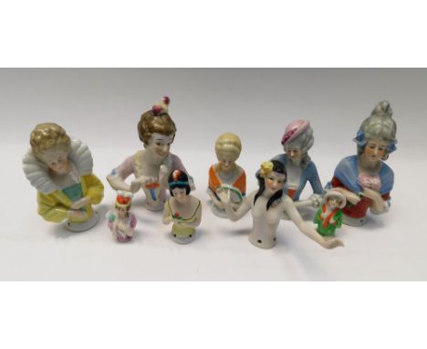 A collection of pin cushion dolls in a variety of styles.