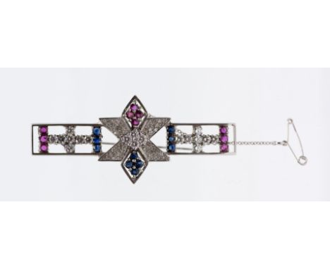 A sapphire, ruby and diamond set 18ct white gold brooch, comprising a open bar form with six sided star motif to the centre, 
