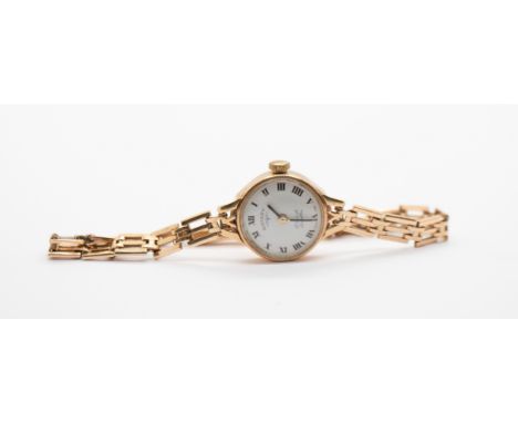 A ladies 9ct gold wrist watch, comprising a round white signed dial with numeral indices, case approx 17mm, to a 9ct gold gat