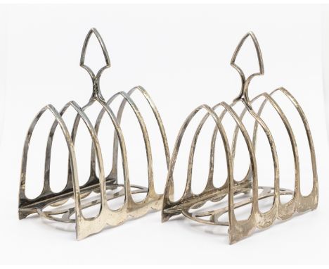 A pair of Edwardian silver five bar toast racks, Gothic arch with stylised supports and handle, hallmarked by William Hutton 