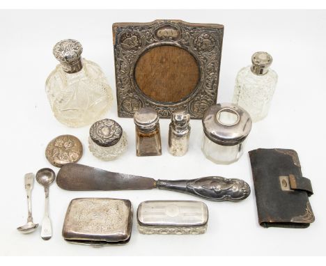 A collection of mixed silver items to include; a small quantity of cut glass and silver topped bottles including a H.W. King 