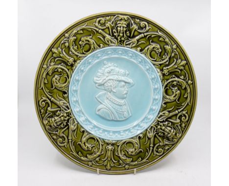 A late 19th century continental Majolica charger with gothic revival border around early 17th century male portrait , chip to