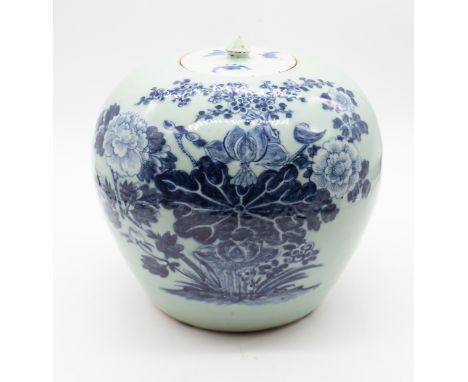 A Chinese celadon glazed and blue and white jar and cover, late Qing Dynasty, painted with lotus and other blossoms, the lid 