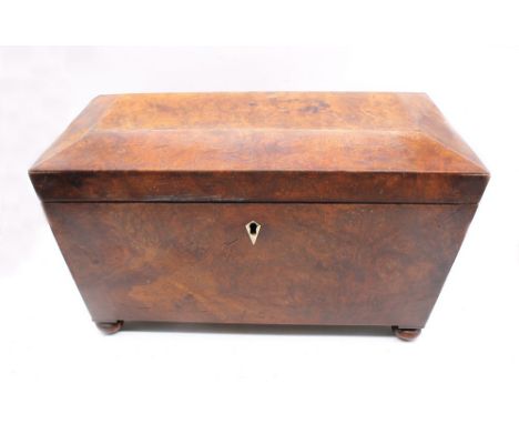 A mid Victorian large walnut tea caddy on bun feet.
