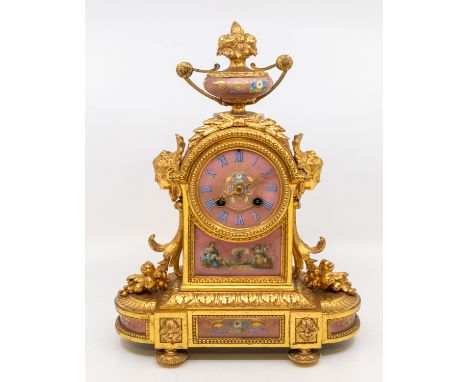 A 19th century J.W. Jeffery &amp; Co of Compton House, Liverpool ornate gilt metal mantle clock, having pink porcelain dial a