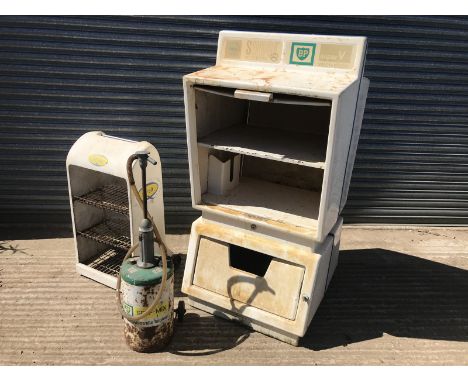 A forecourt oil bottle, oil tin dispenser, a BP self-mixer and a Duckhams forecourt rack. 