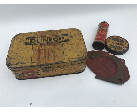 A Dunlop car size tyre repair outfit with assorted contents.