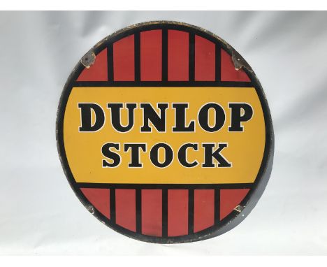 A Dunlop Stock circular enamel sign, dated June 1953, slight fading to lower half, 24" diameter.