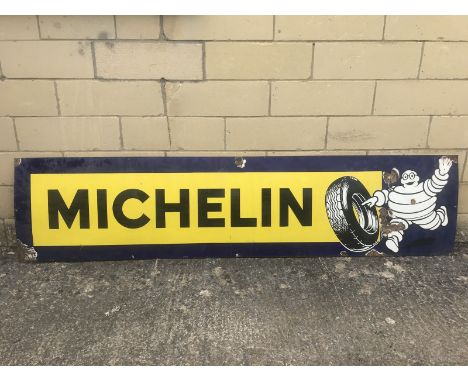 A Michelin rectangular enamel sign with image of Mr. Bibendum rolling a tyre to one end, 78 3/4 x 18 1/2". 
