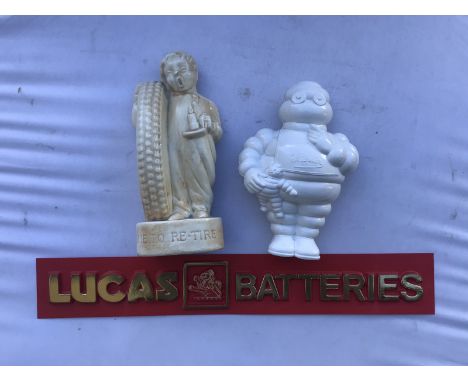 A Lucas Batteries plastic shelf strip, a plastic model of Mr Bibendum and a modern Fisk Tyres pottery money box.