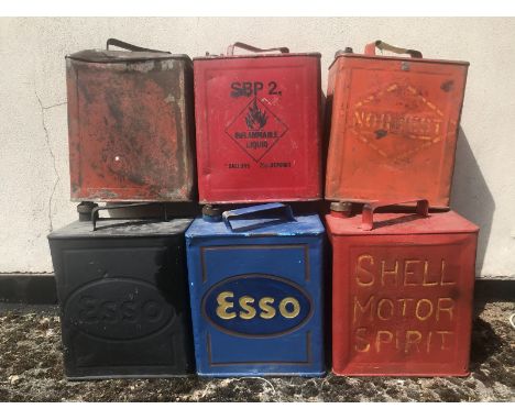 Six 2 gallon petrol cans including Esso and Shell. 